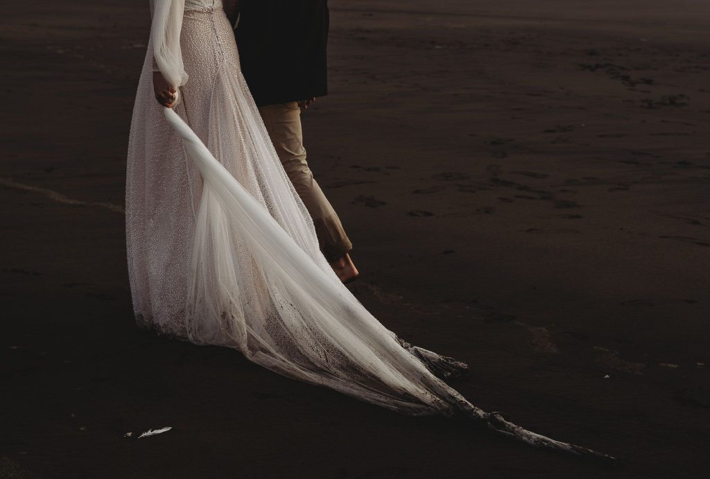 girl holding bridal dress - Auckland Wedding Photographer