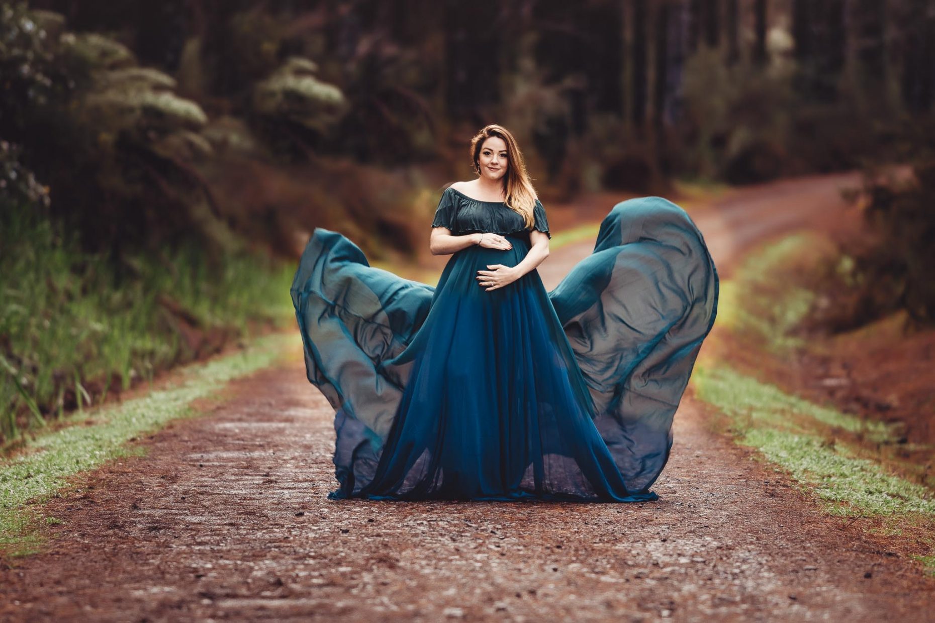 pregnant lady in green dress and smiling