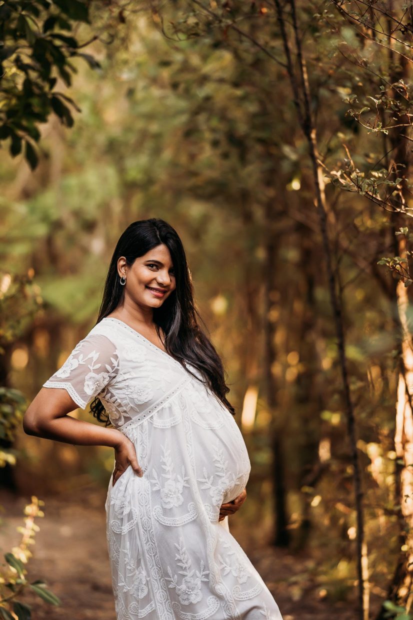 pregnant lady in white maxi smiling - Maternity photoshoots Auckland - amber Farooq