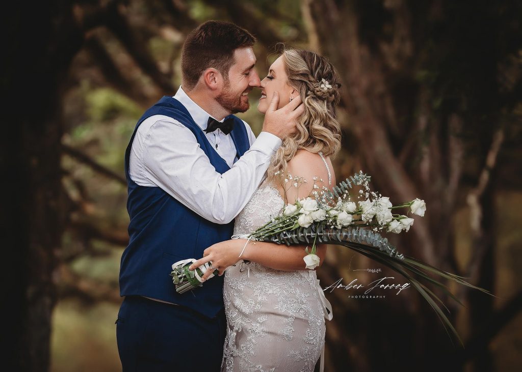 groom kissing bride at Kumeu during sunset - Auckland Wedding Photographer