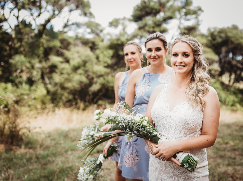 bride with flowers - Auckland Wedding Photographer