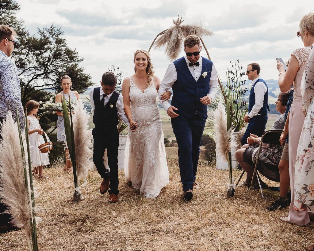 Auckland wedding bride and groom walking down the aisle - Auckland Wedding Photographer