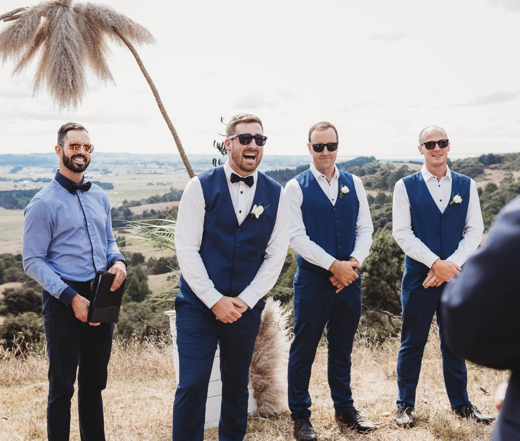 groom smiling after seeing bride in Auckland wedding bride and groom first look photo session - Auckland Wedding Photographer