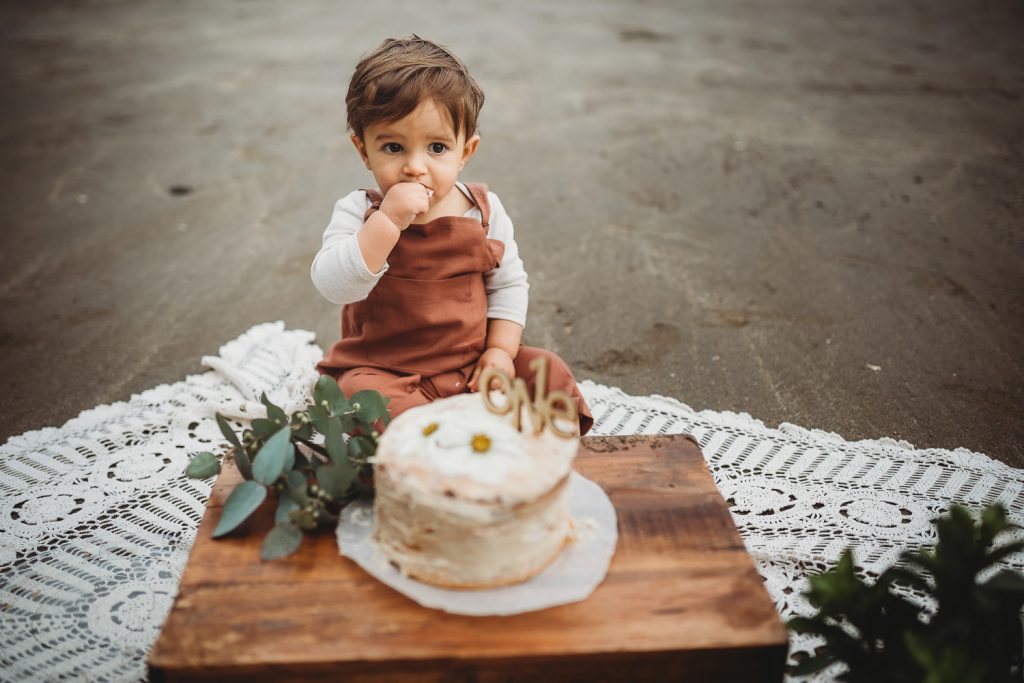 one year old boy eating cake