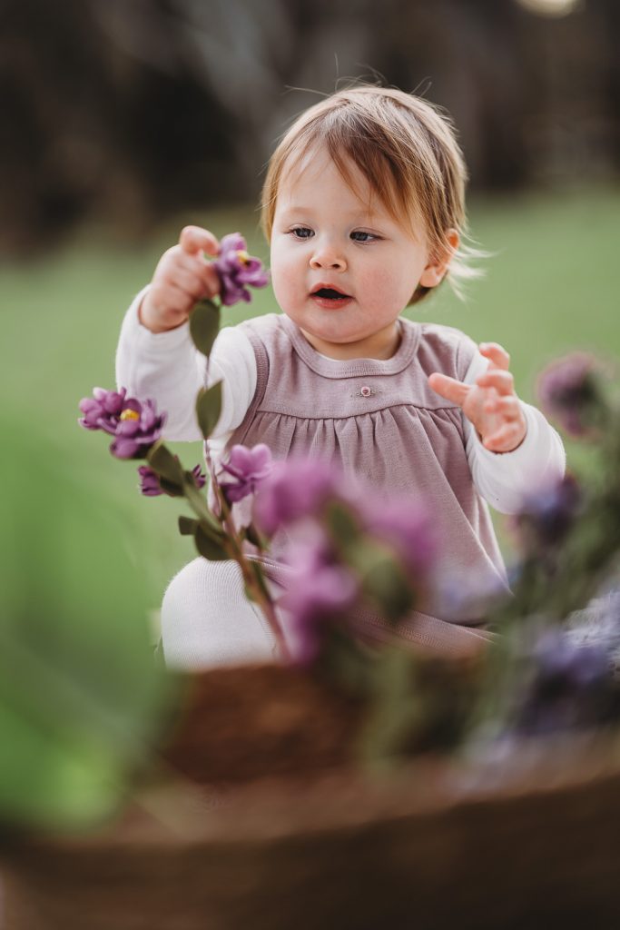 one year old girl with flowers