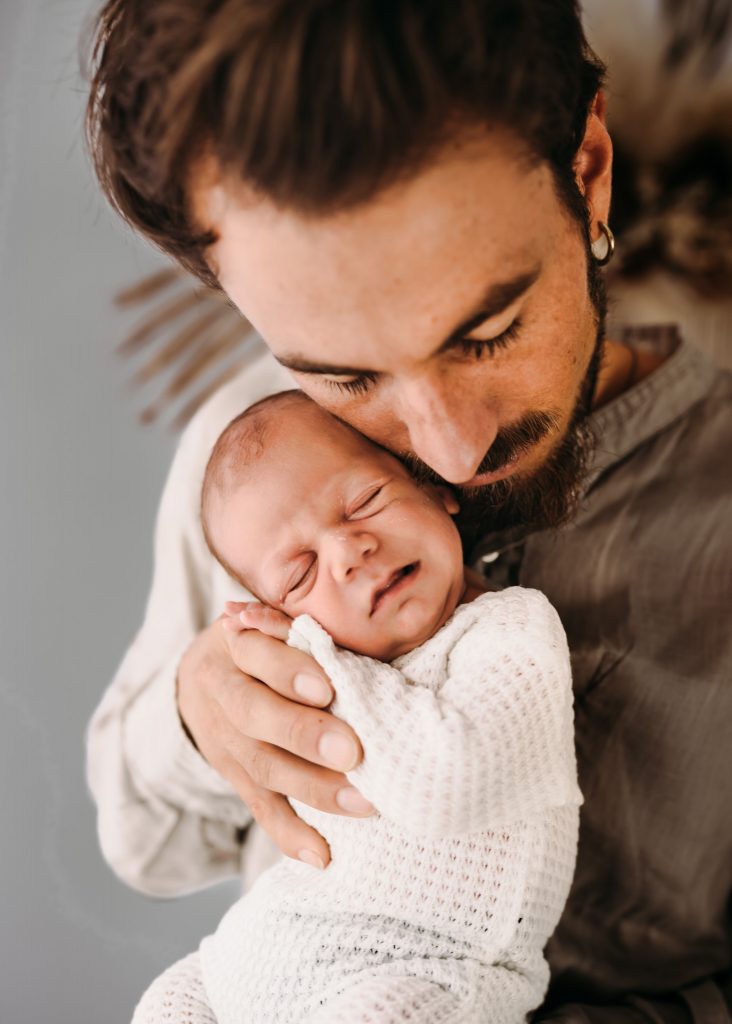 father kissing his son