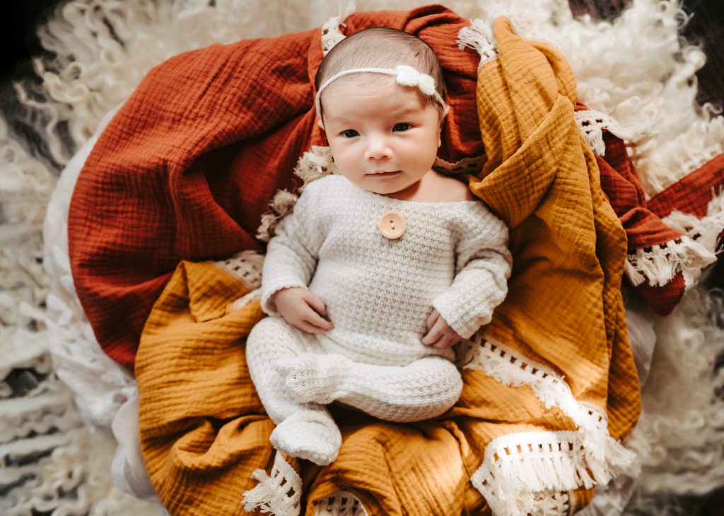 newborn on colorful bedsheet