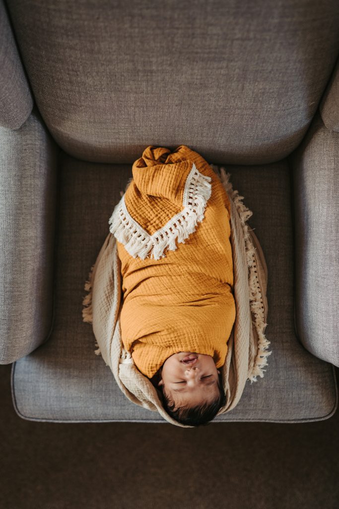 newborn sitting on sofa