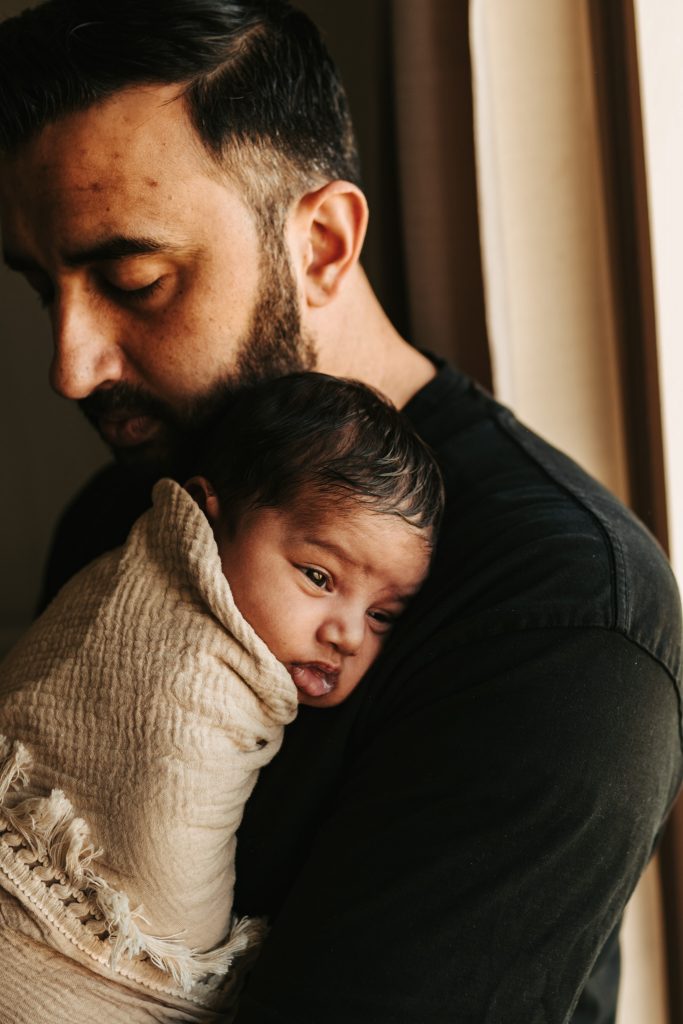 newborn with his father