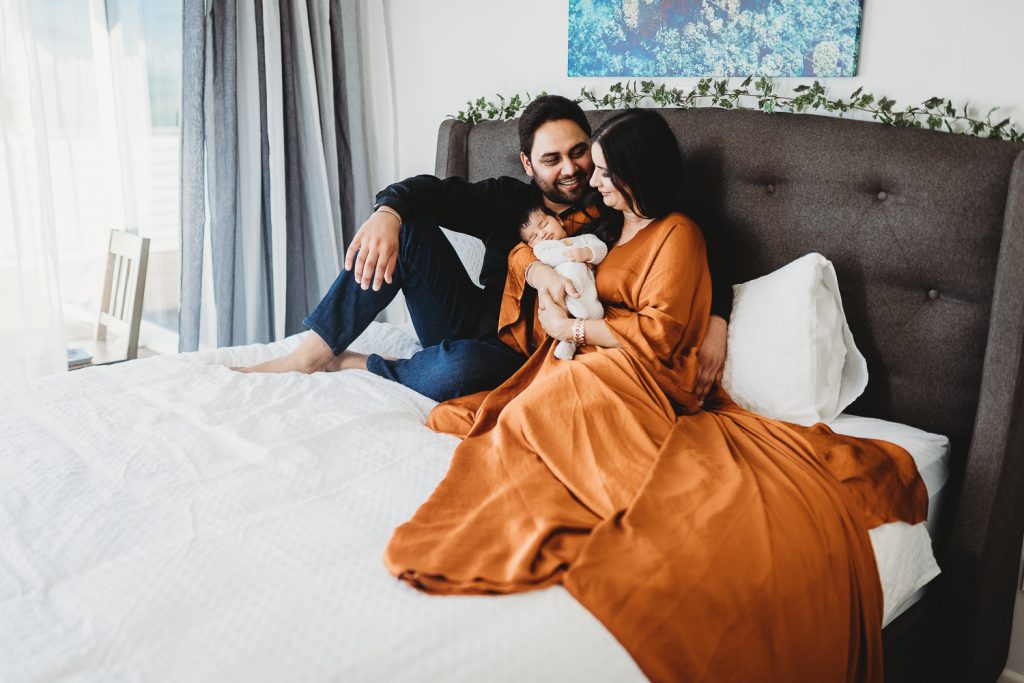 dad looking at mum with newborn
