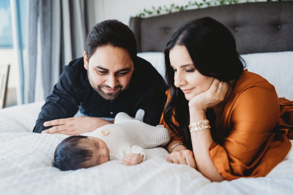 parents looking at newborn