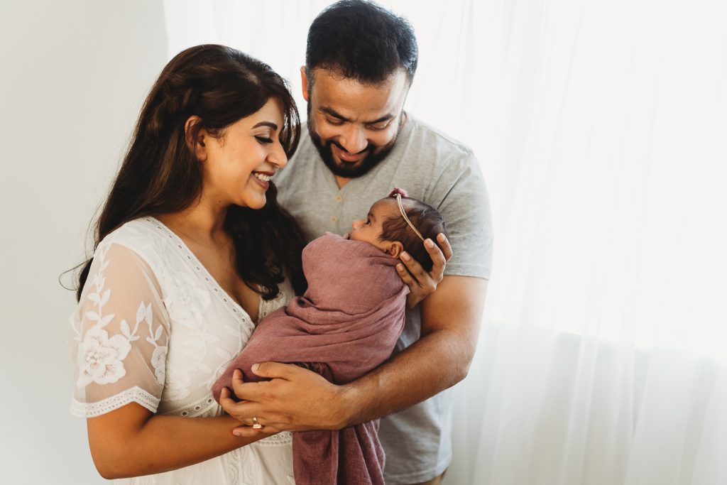 proud parents looking at newborn