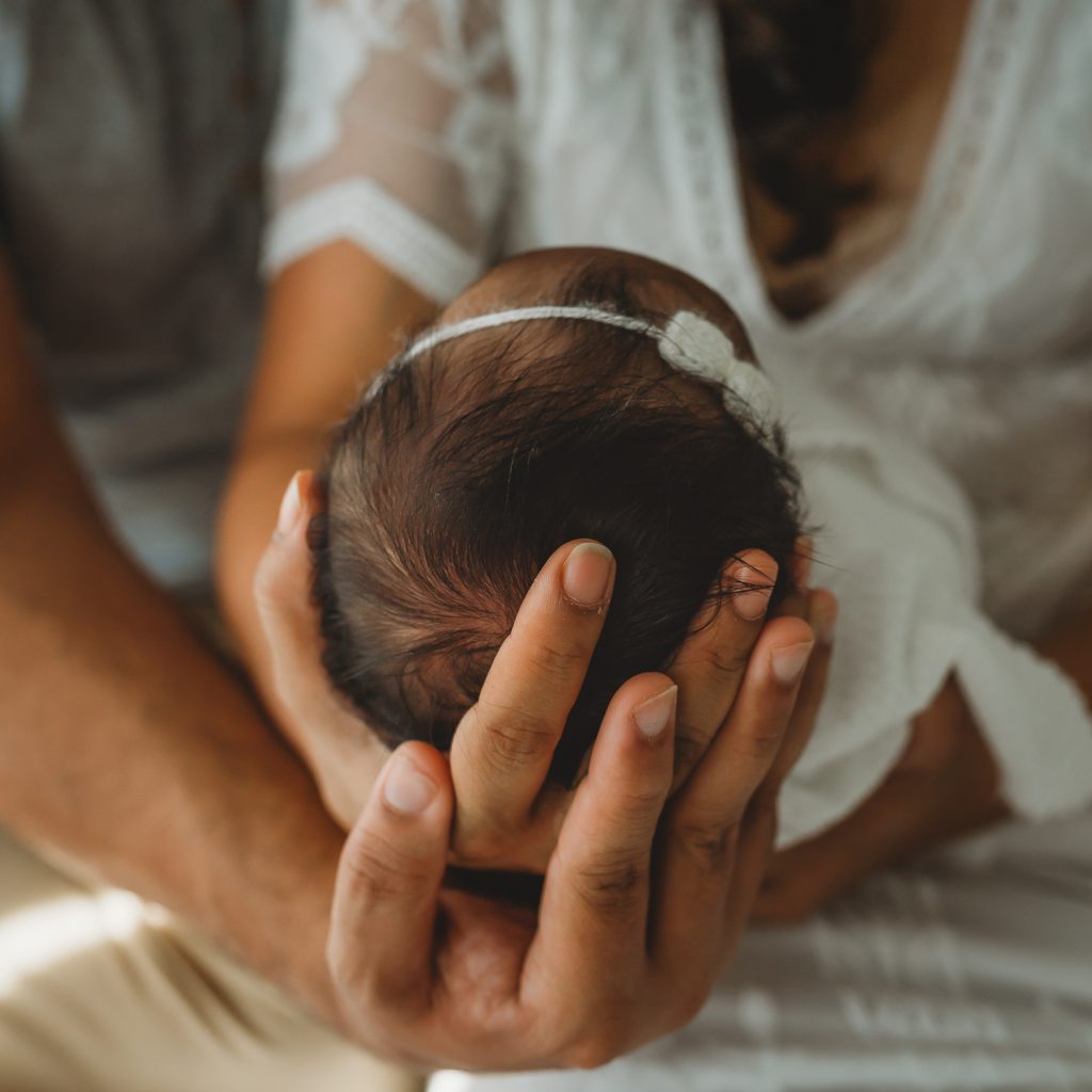 newborn in parents arms