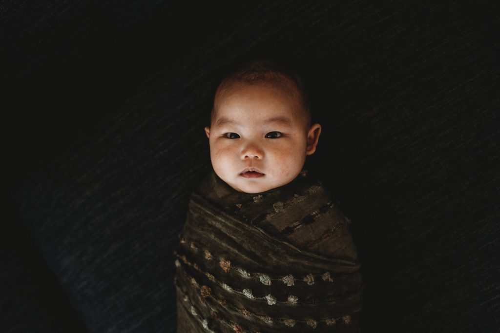 newborn wrapped in green cloth - Auckland Newborn Photographer, Lifestyle, Amber Farooq