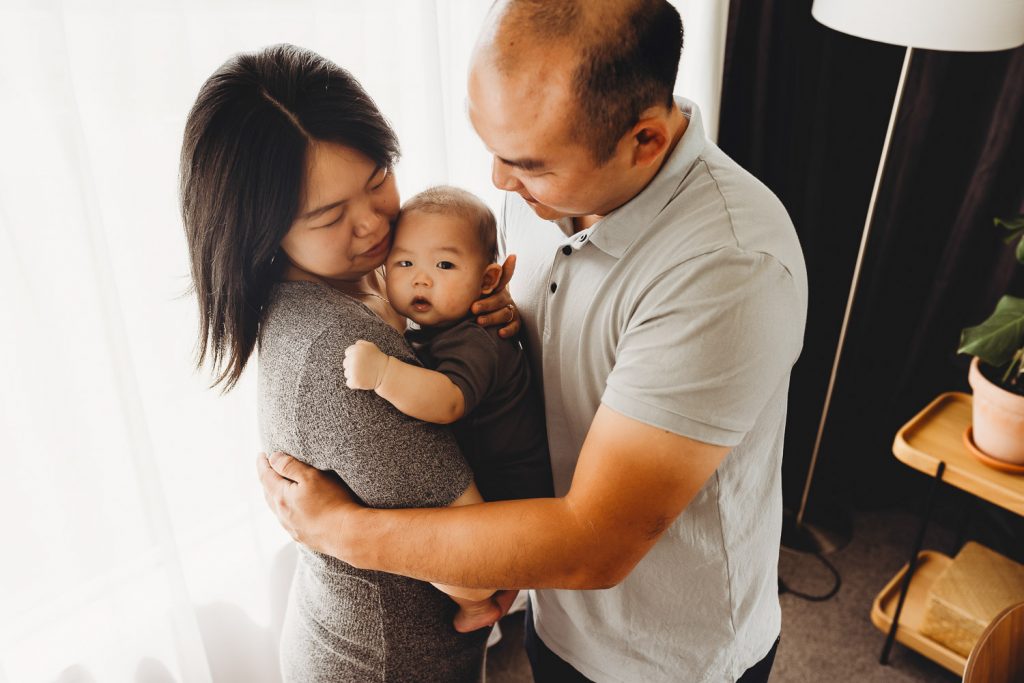 father looking at newborn - Auckland Lifestyle Newborn Photographer Amber Farooq