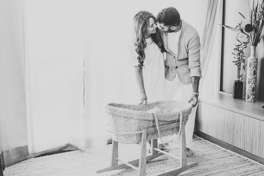 mother father hugging standing near newborn - Auckland Lifestyle Newborn Photographer Amber Farooq