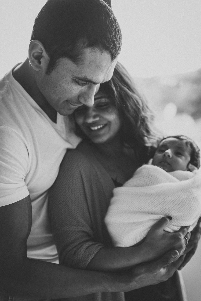 mother web newborn hugging father - Auckland Lifestyle Newborn Photography Amber Farooq