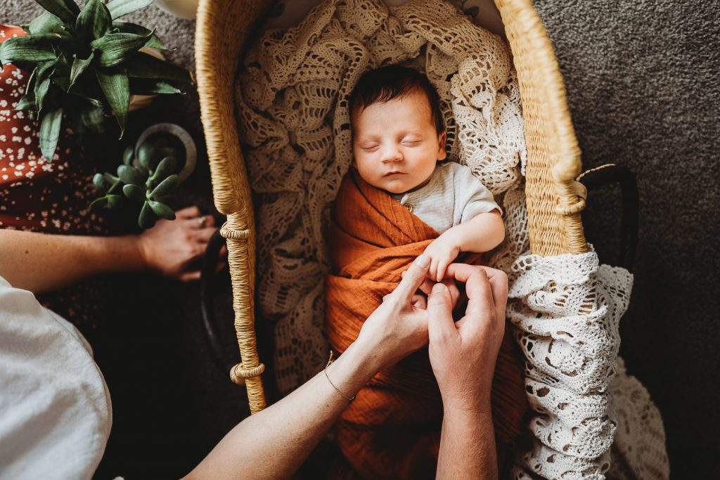 mother father holding newborn hand - Auckland Lifestyle Newborn Photographer Amber Farooq
