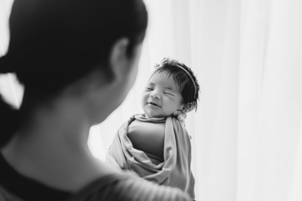 mother smiling with newborn – Auckland studio newborn photographer