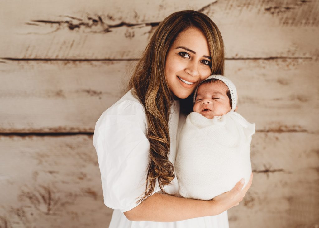 mother smiling with newborn – Auckland studio newborn photographer