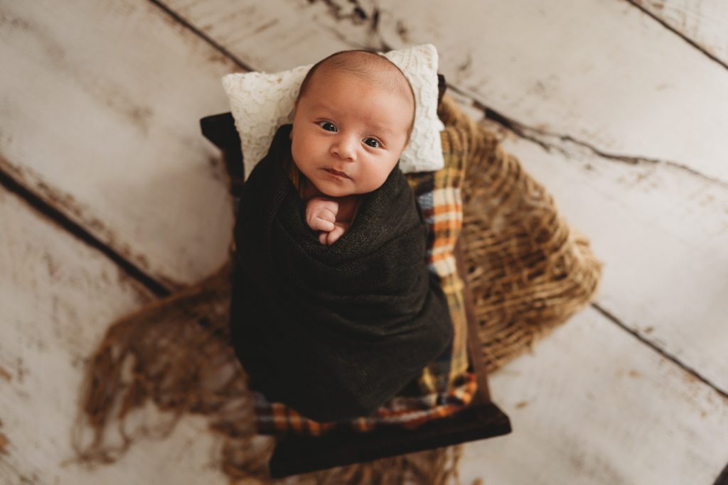 newborn awake on bed – Auckland studio newborn photographer