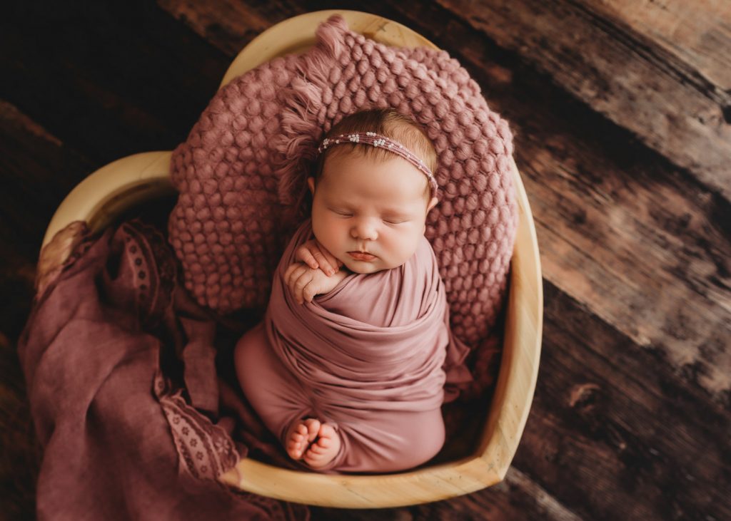 newborn in heart bowl– Auckland studio newborn photographer
