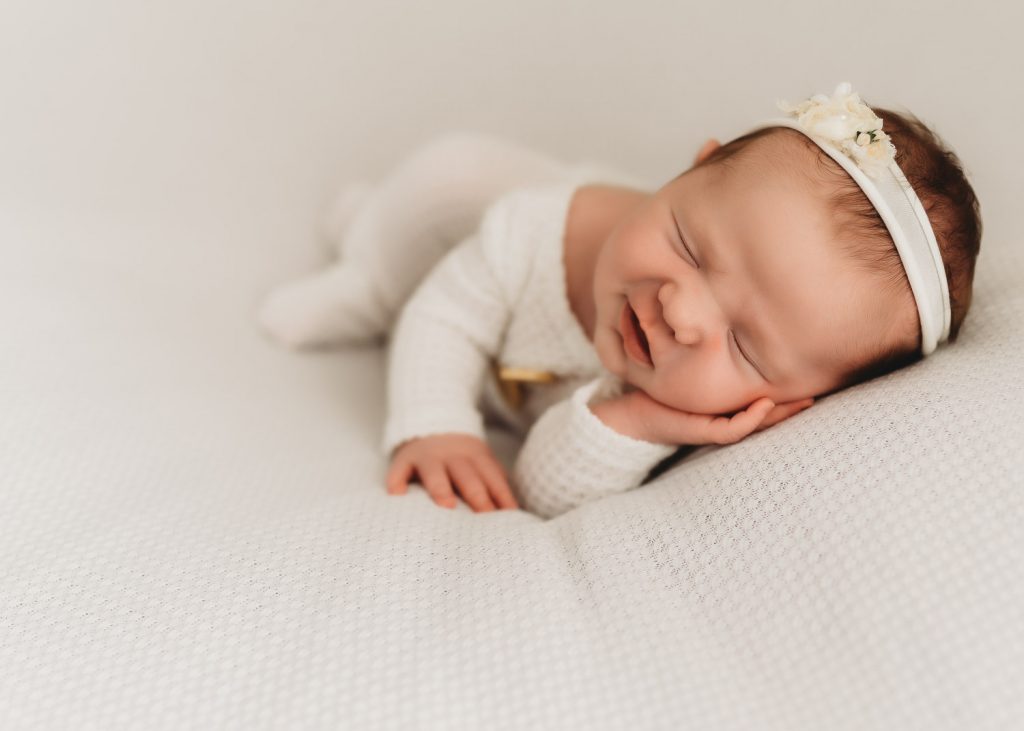 newborn sleeping with a smile – Auckland studio newborn photographer