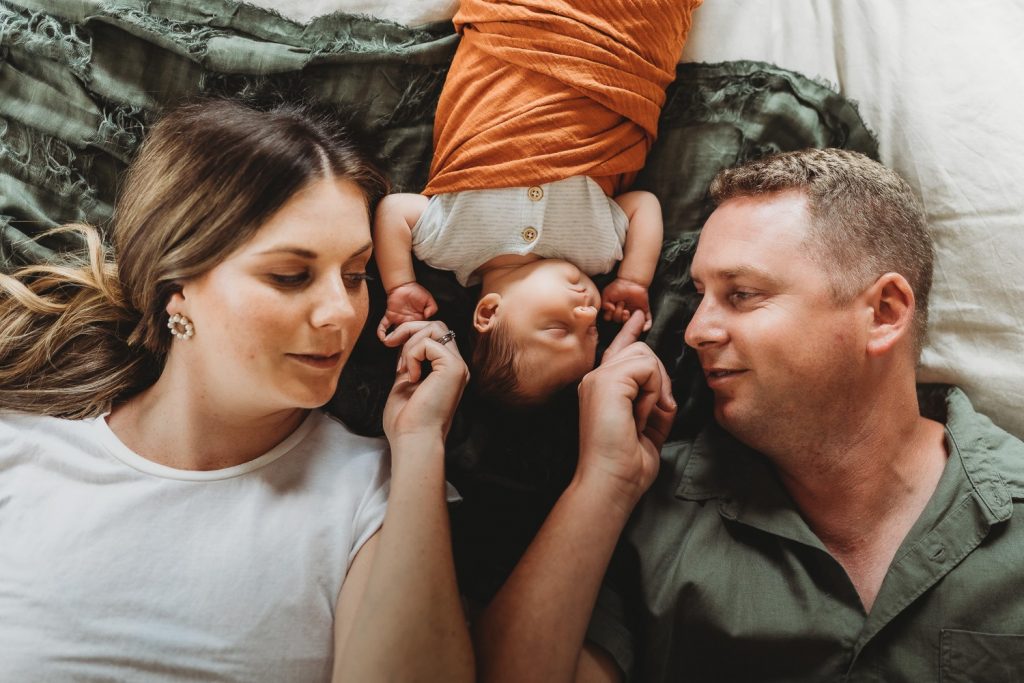 mother and father holding newborn hands - Auckland Newborn Photography