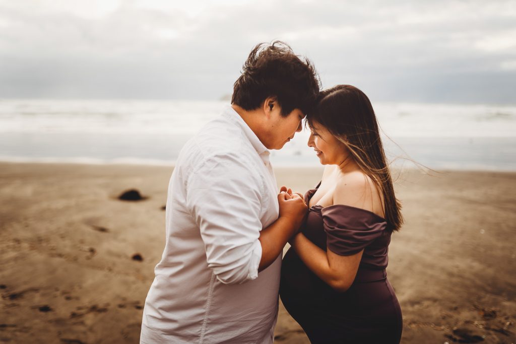 Husband and wife embrace - maternity photography in auckland