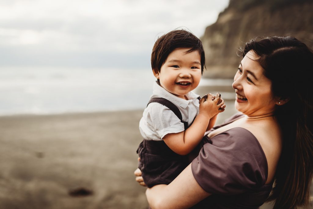 pregnant women smiling during maternity photography in auckland with his son