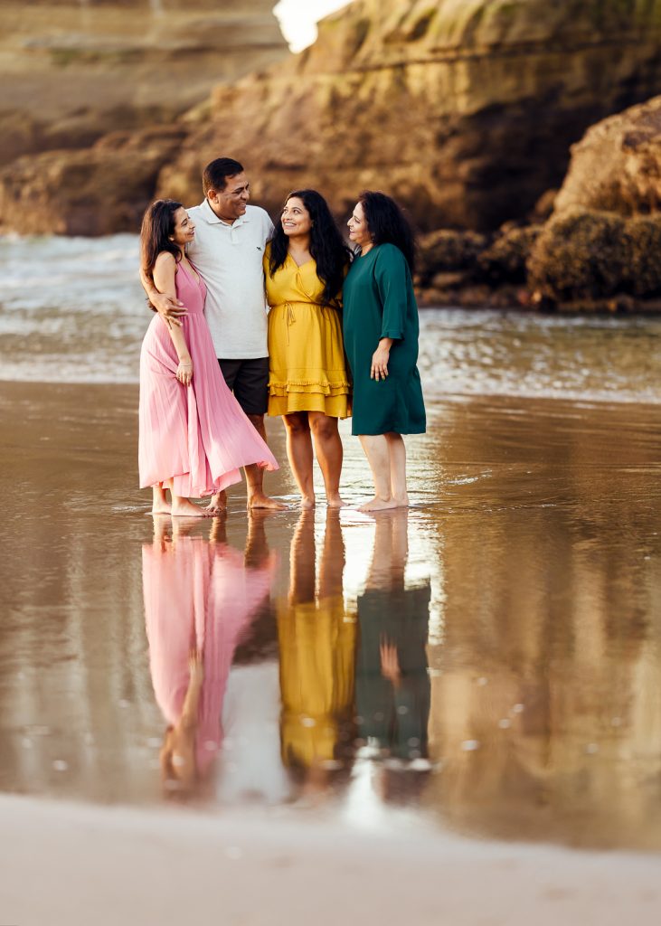 family standing on the beach