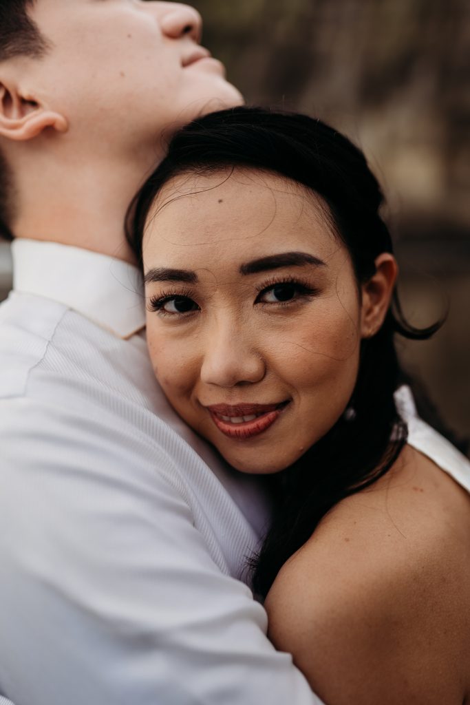 A Singaporean couple, Lishan and Ernest, celebrate their honeymoon in Auckland with romantic portraits at Muriwai Beach.