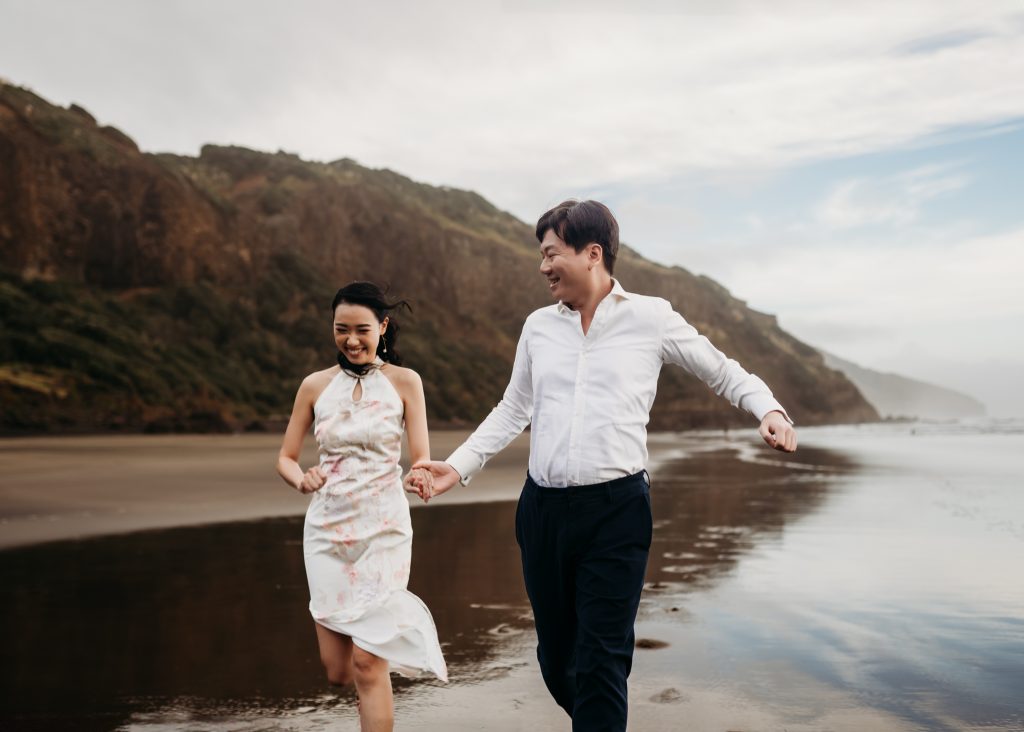 A romantic portrait captures Lishan gazing lovingly into Ernest's eyes during their Muriwai Beach honeymoon photoshoot.