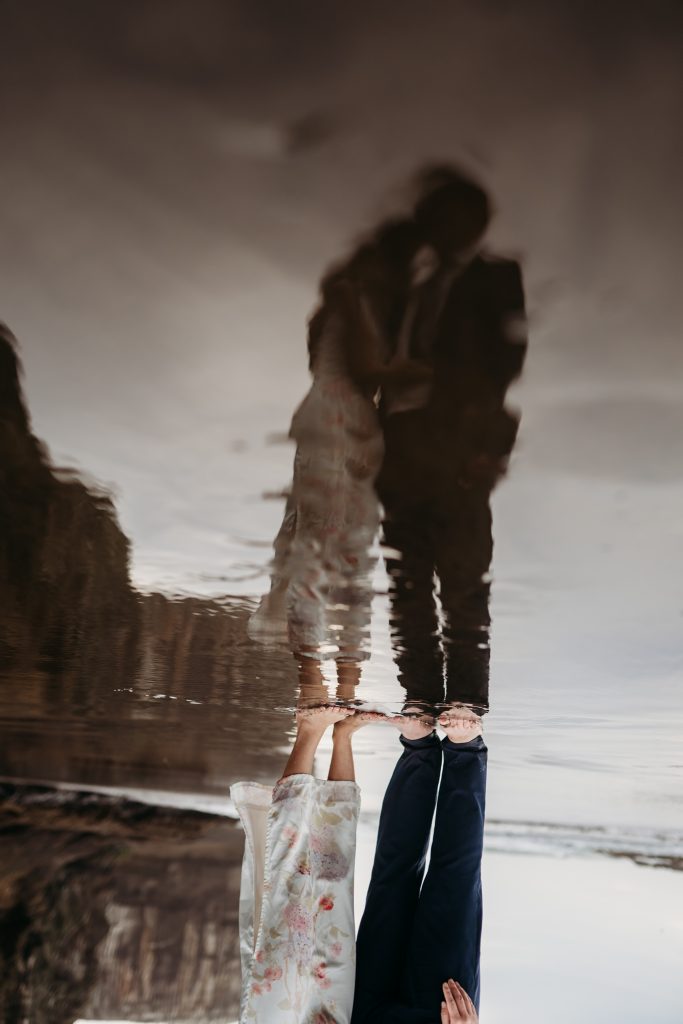Lishan and Ernest share a tender moment on the beach, bathed in the golden light of sunset during their honeymoon shoot.