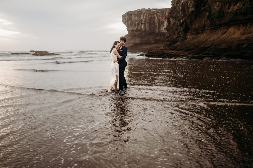 Fresh off their Singapore wedding, Lishan and Ernest capture their love story on a honeymoon photoshoot at Muriwai Beach.