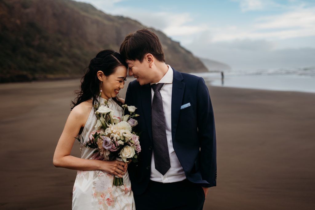 Auckland's Muriwai Beach provides a breathtaking backdrop for Lishan and Ernest's honeymoon portraits.