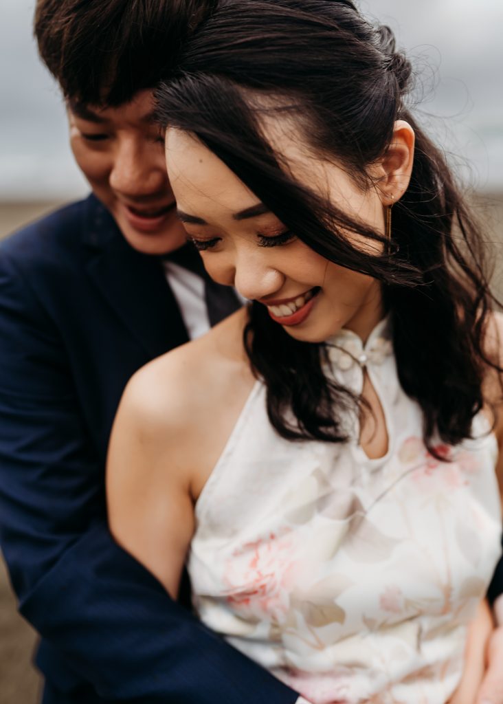 A love story unfolds: A honeymoon photoshoot at Muriwai Beach captures the beauty of Lishan and Ernest's lasting bond.