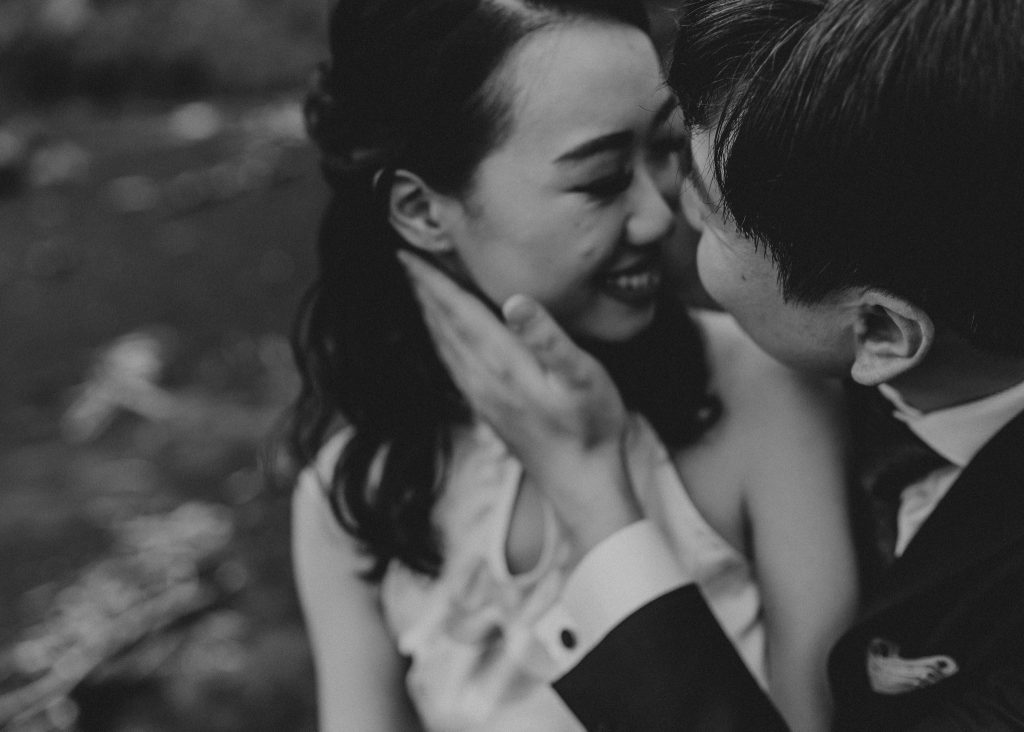 Love and laughter on the shore: Lishan and Ernest's honeymoon photoshoot at Muriwai Beach is filled with romance and connection.