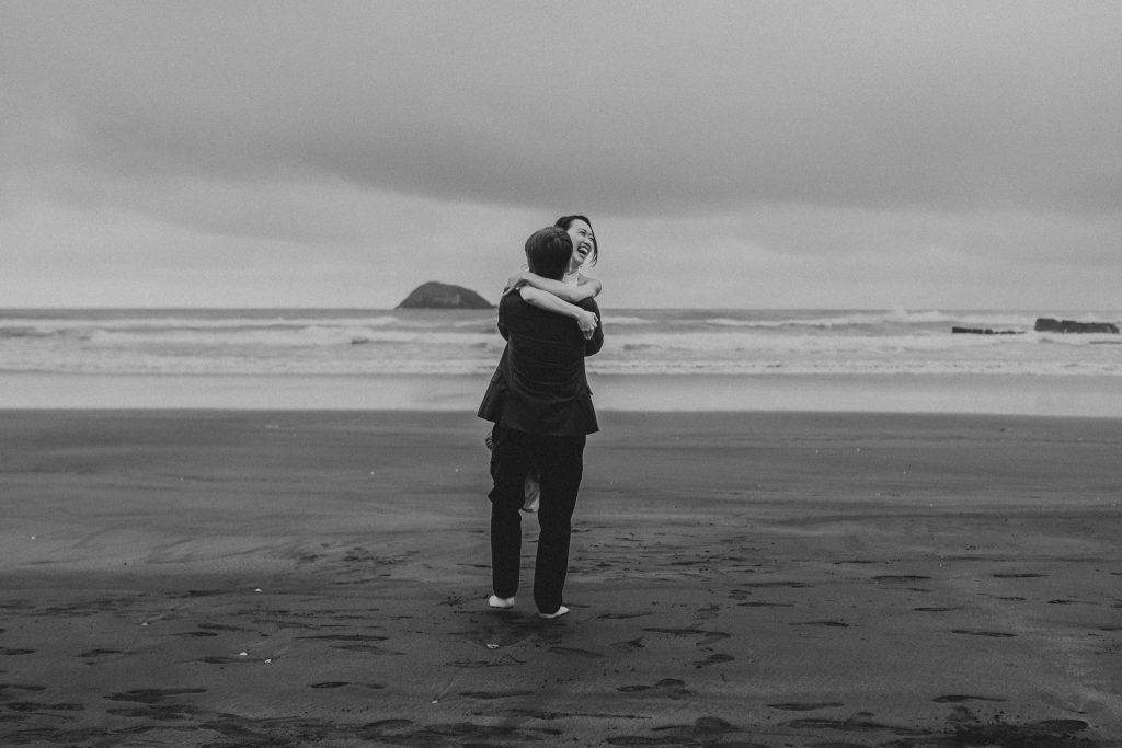 Lishan and Ernest, a newly married couple from Singapore, celebrate their honeymoon with a romantic photoshoot at Auckland's Muriwai Beach.