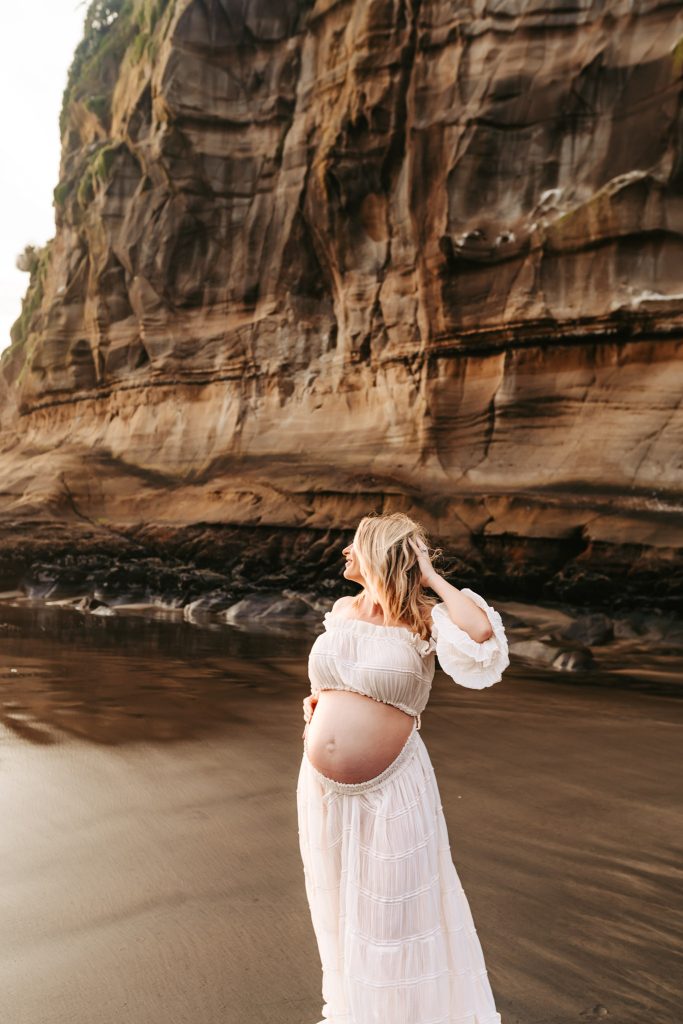 Auckland maternity pictures: Black and white photo of a pregnant belly with a heart shape drawn on it.