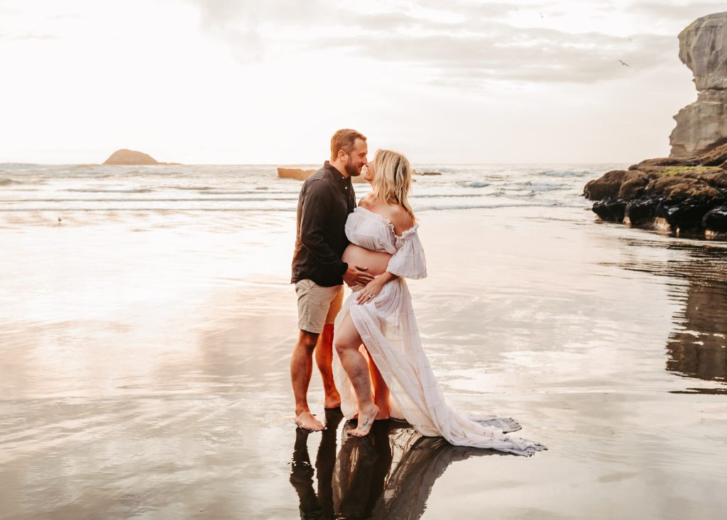 Auckland maternity photoshoot: Joyful expecting mother laughs with her partner on a vibrant Auckland street.