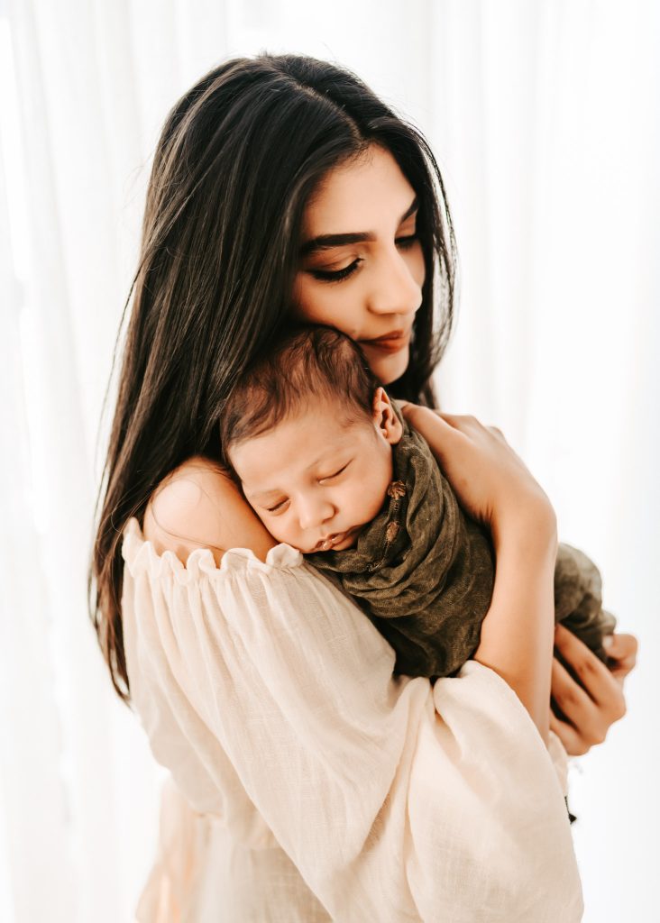 The love between a family is born: A newborn lifestyle photoshoot documents Arham's arrival and his parents' affection.