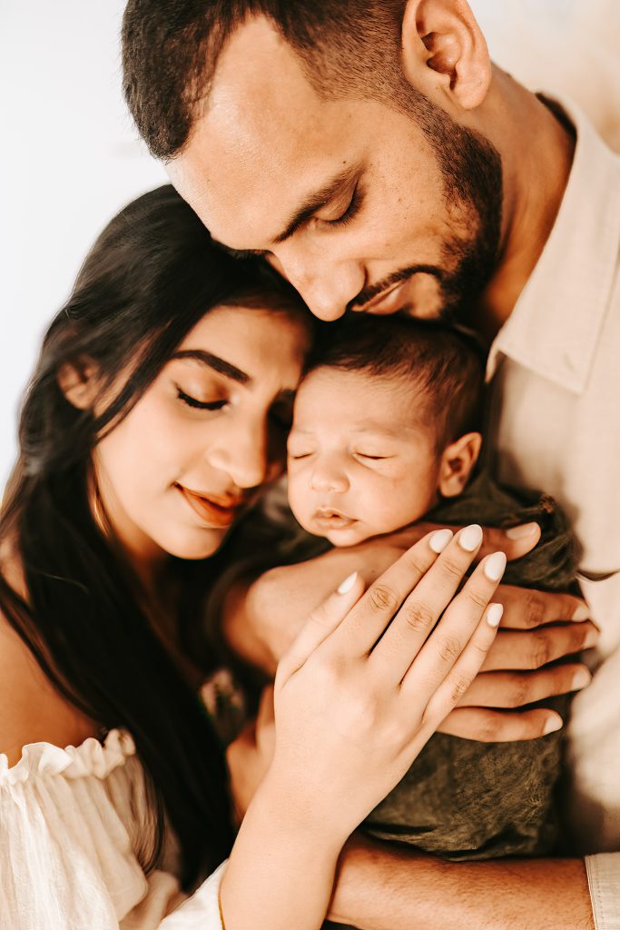 Auckland newborn photographer: A lifestyle session showcasing the tender bond between Arham and his loving parents