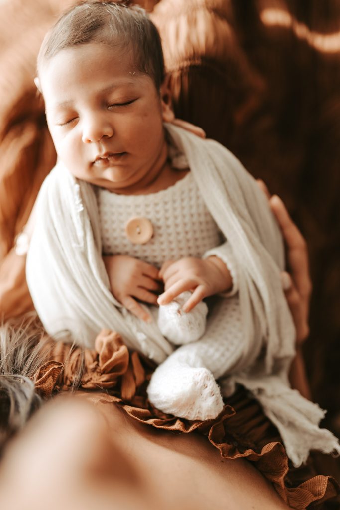 Preserving precious moments: A newborn lifestyle session documents Arham's peaceful slumber and his parents' love.