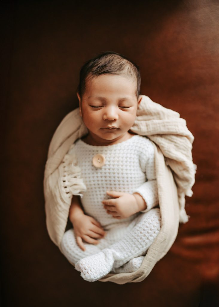 Auckland in-home newborn photography: Arham's parents shower him with love in a natural light lifestyle session.