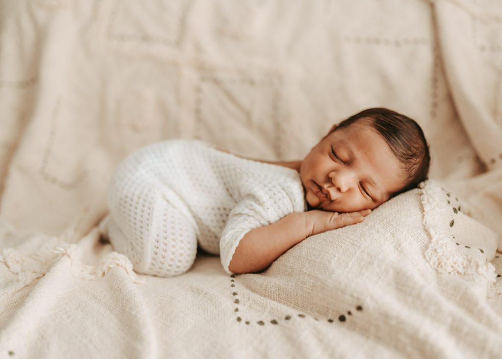 Auckland newborn photographer: Mom and Dad bond with their precious baby Arham in a natural light lifestyle shoot.