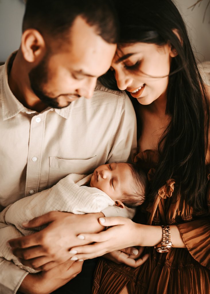 Arham, a peaceful newborn, rests comfortably during his Auckland newborn lifestyle photoshoot.
