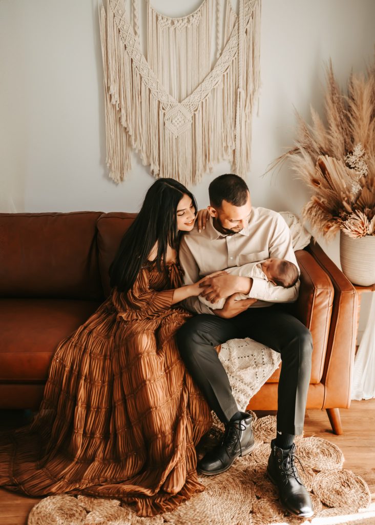 Two-week-old Arham nuzzles close to his parents, capturing the love and connection in a newborn lifestyle session.