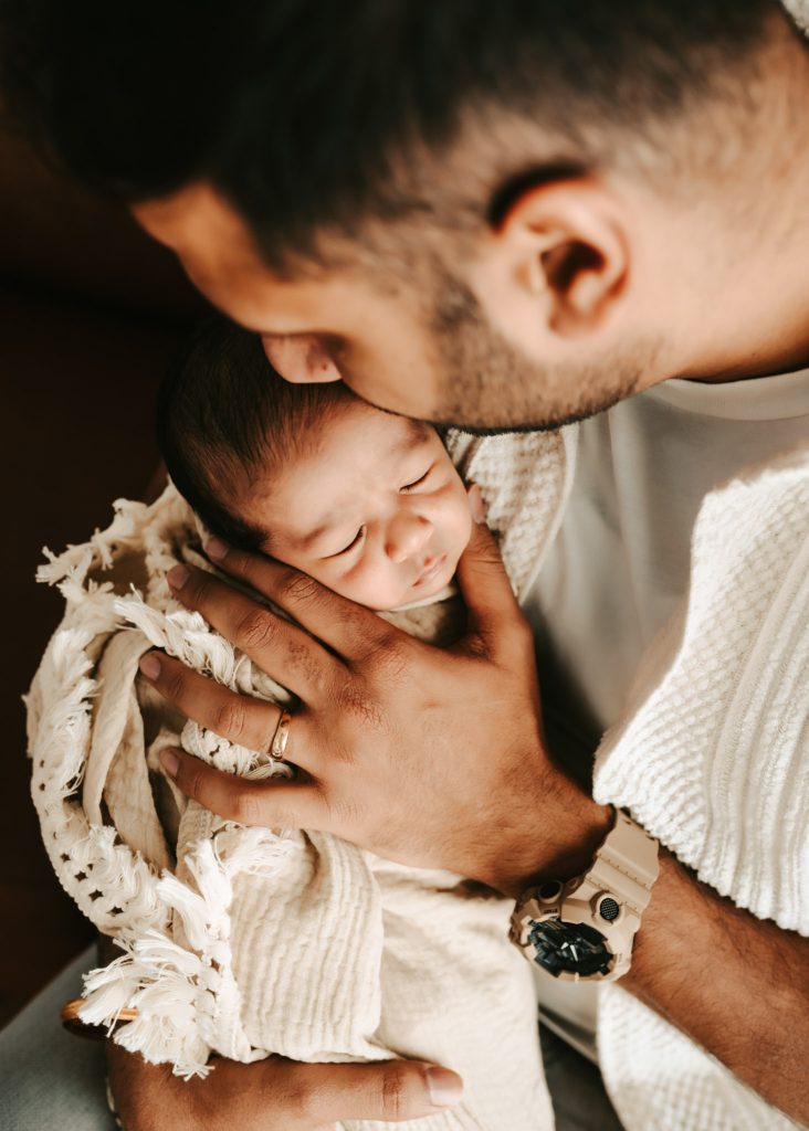 Newborn wonder in Auckland: A studio photoshoot captures Niam's first days with his loving family.