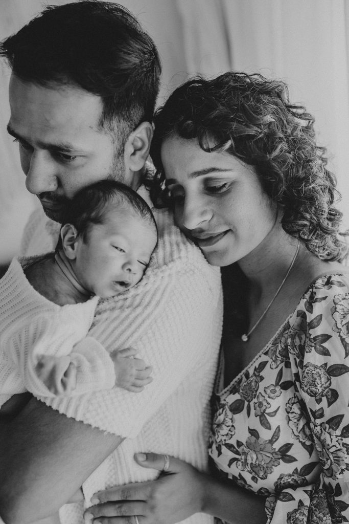 The magic of studio newborn photography: Soft light and calming colors create a serene portrait of Niam.